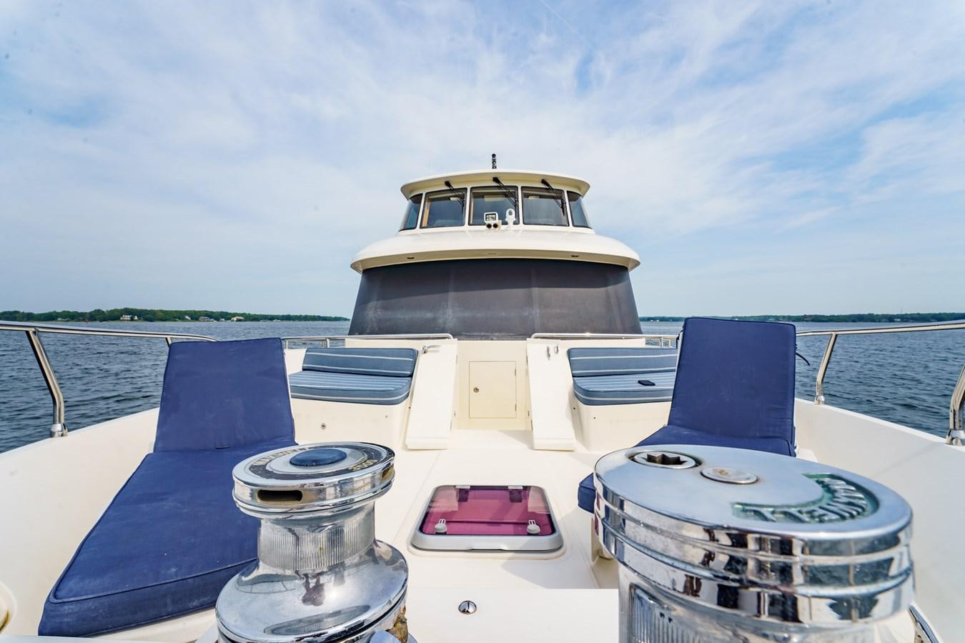 a boat on a body of water aboard THREE OF A KIND Yacht for Sale
