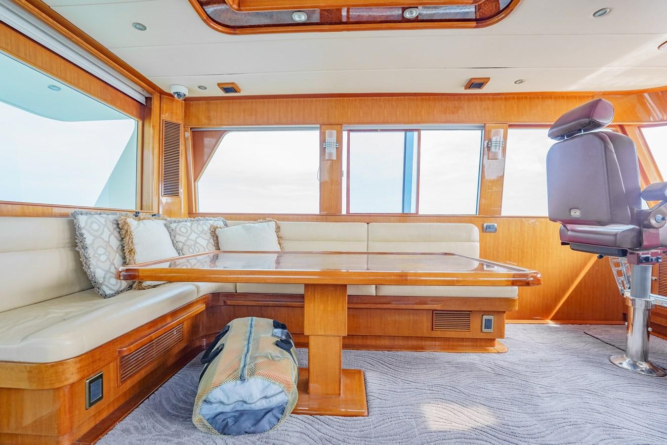 a living room with a couch and a table aboard THREE OF A KIND Yacht for Sale