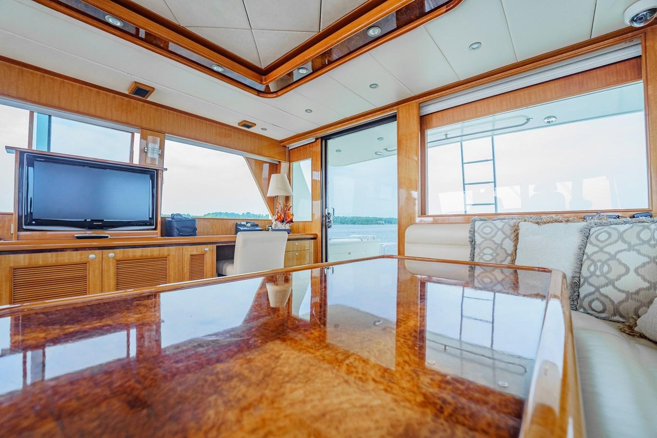a living room with a large tv aboard THREE OF A KIND Yacht for Sale