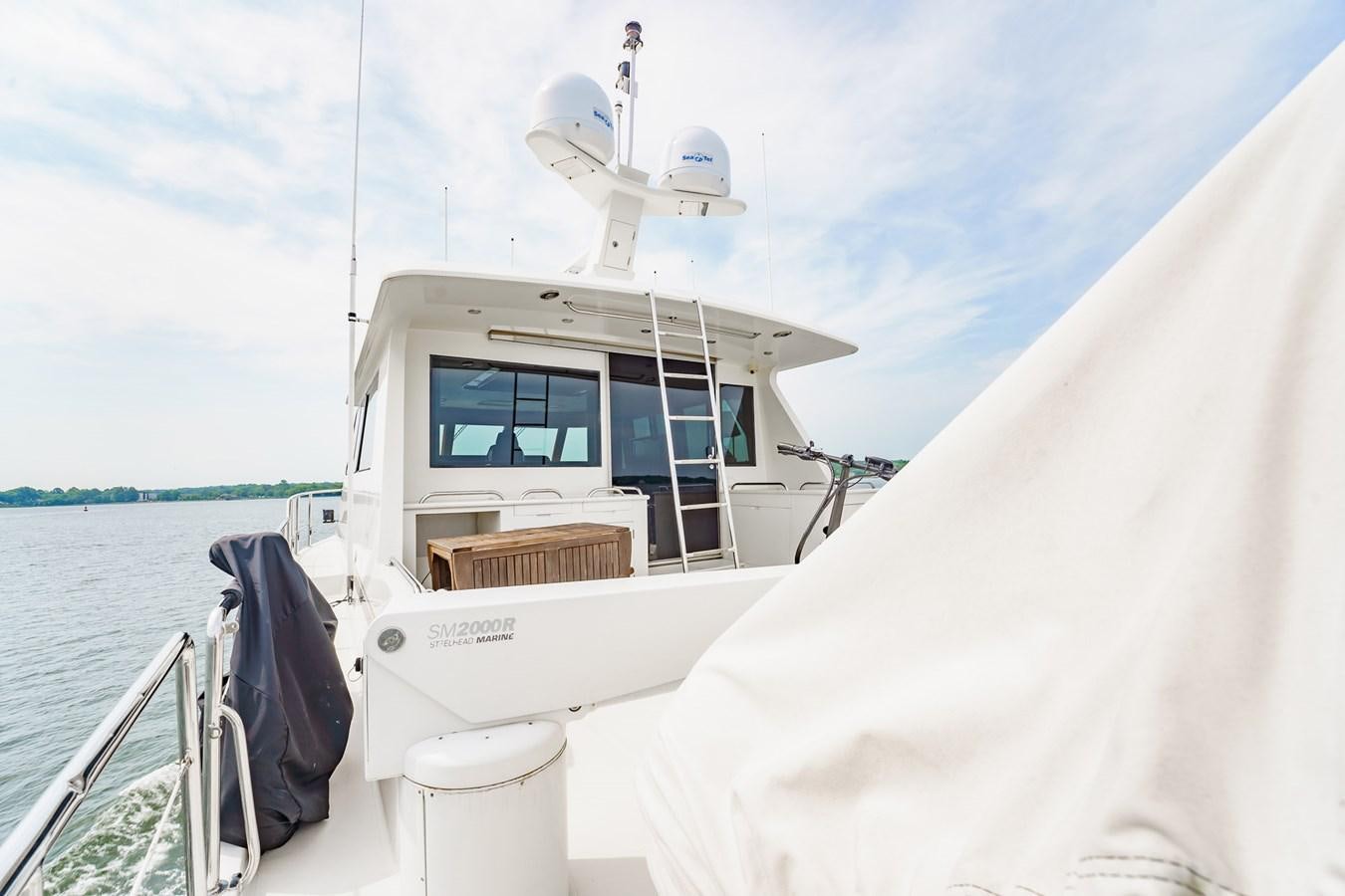 a boat with a satellite on it aboard THREE OF A KIND Yacht for Sale