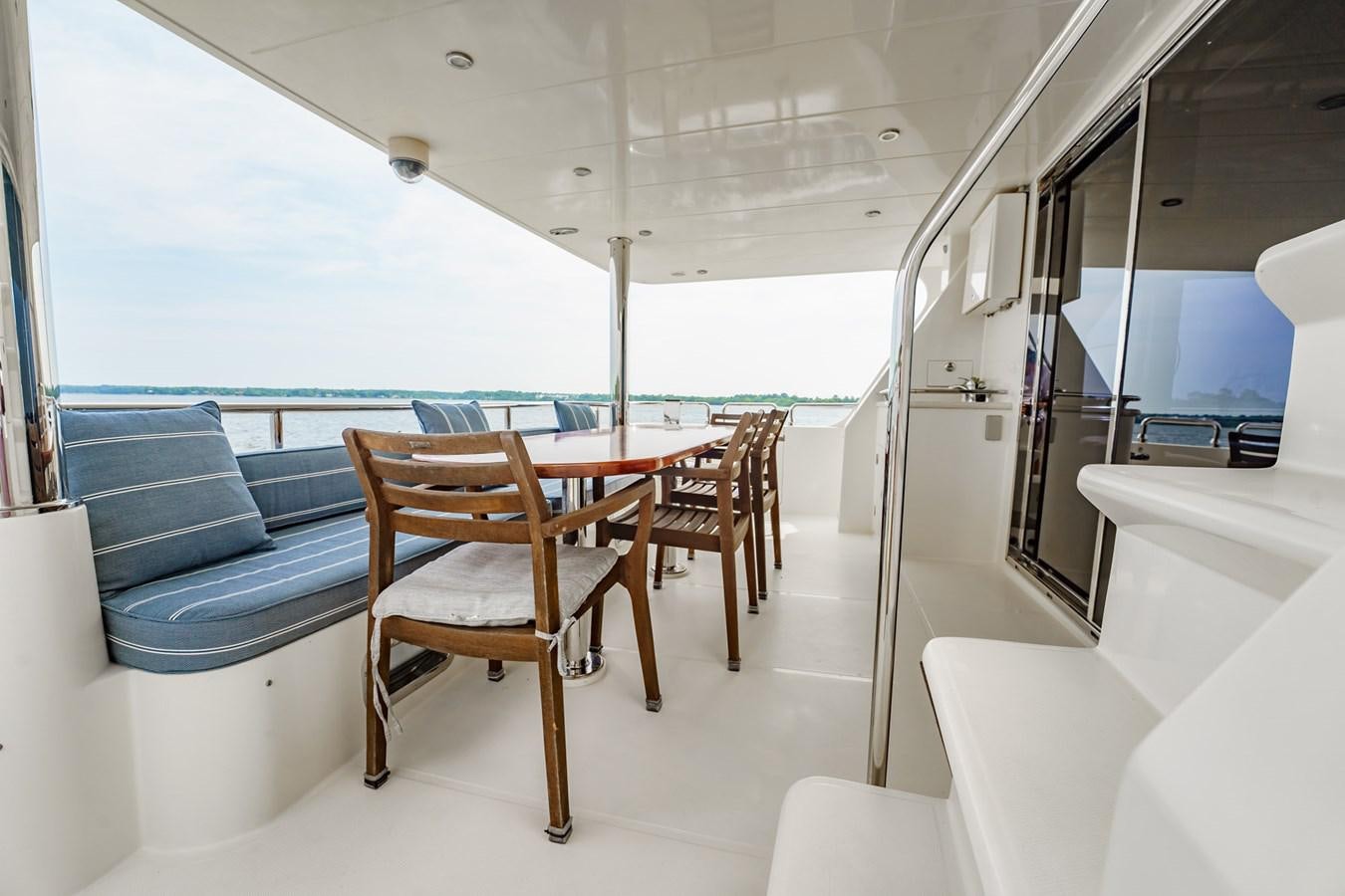 a table and chairs on a boat aboard THREE OF A KIND Yacht for Sale