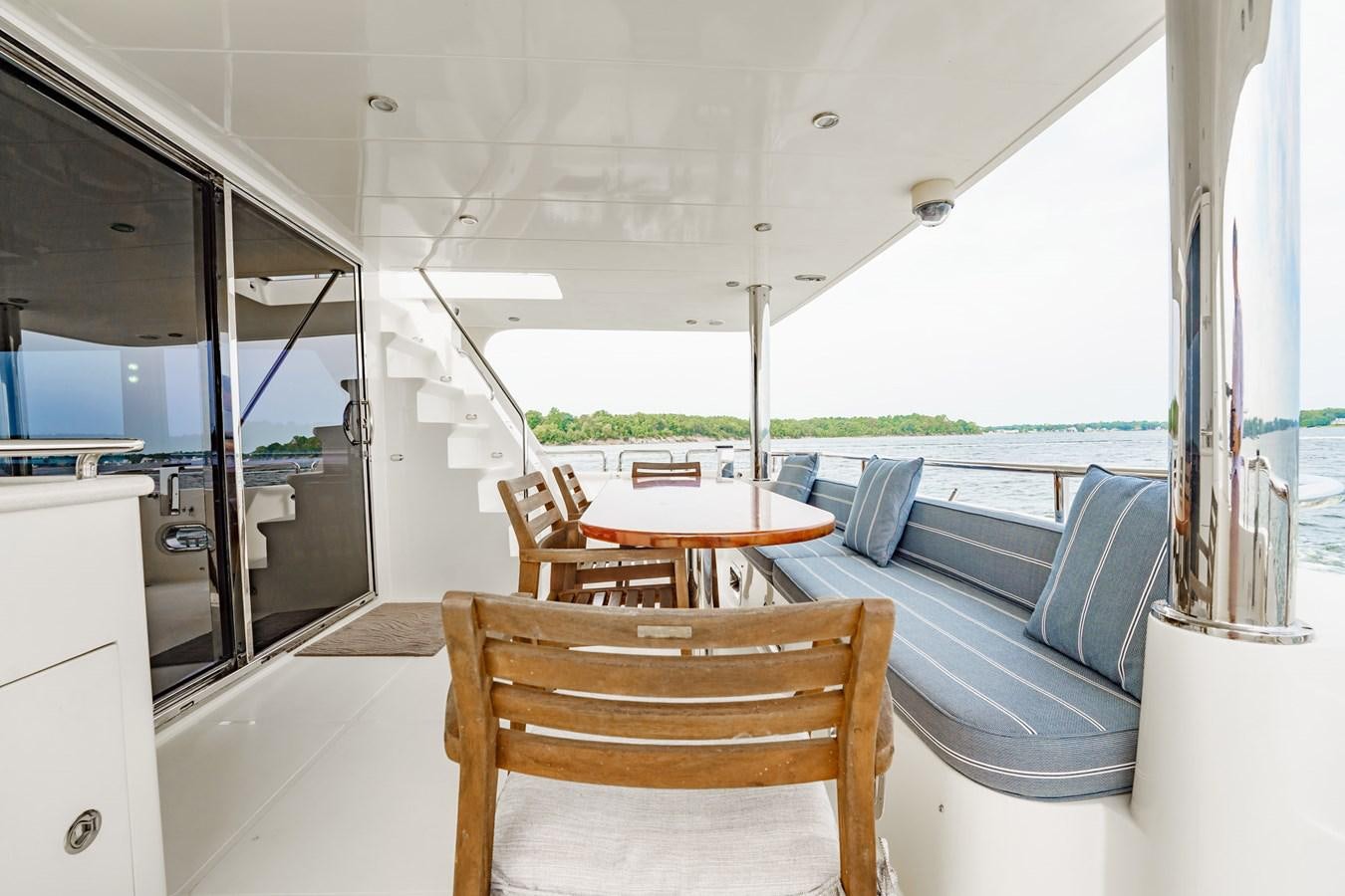 a boat with a table and chairs aboard THREE OF A KIND Yacht for Sale