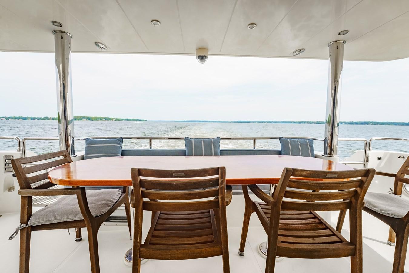 a table and chairs on a patio aboard THREE OF A KIND Yacht for Sale