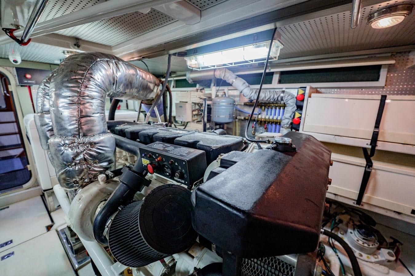 a large grey dinosaur in a factory aboard THREE OF A KIND Yacht for Sale