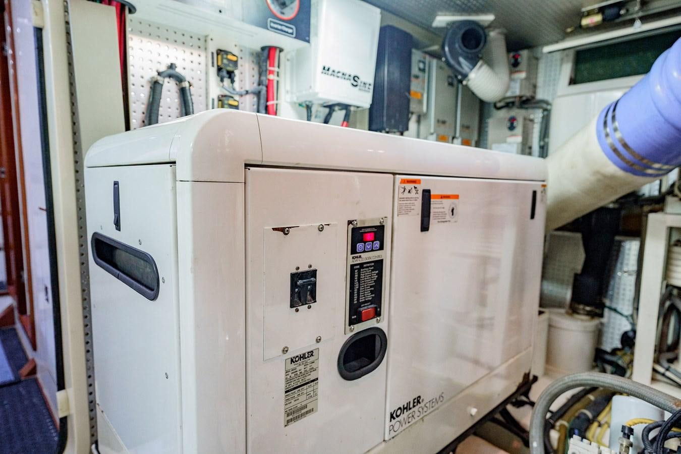 a machine in a room aboard THREE OF A KIND Yacht for Sale