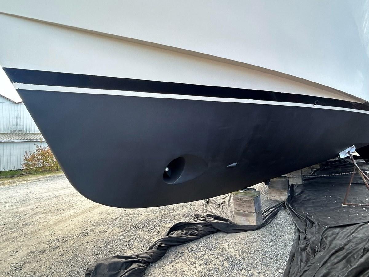 a black and white boat aboard THREE OF A KIND Yacht for Sale