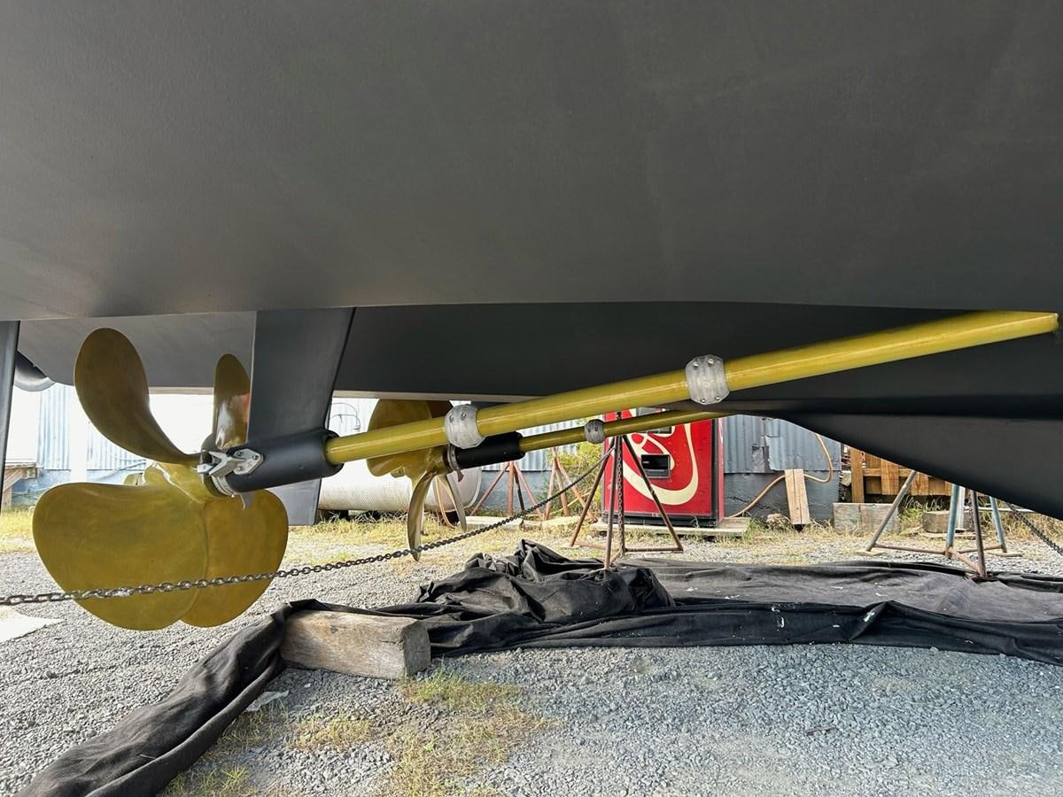 a yellow and black airplane with a propeller on it aboard THREE OF A KIND Yacht for Sale