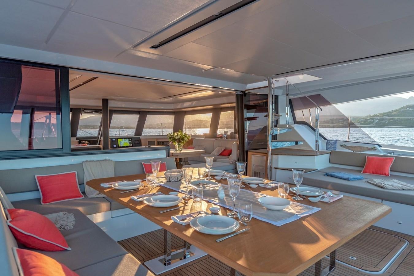 a table with plates and cups on it aboard ALEGRIA 67 Yacht for Sale