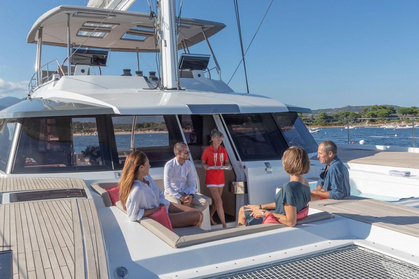 a group of people sitting on a boat aboard ALEGRIA 67 Yacht for Sale