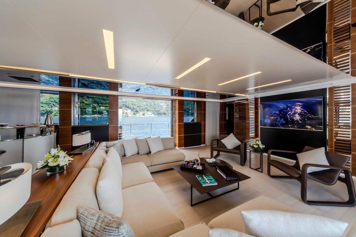 a living room with a large screen aboard LADY A Yacht for Sale