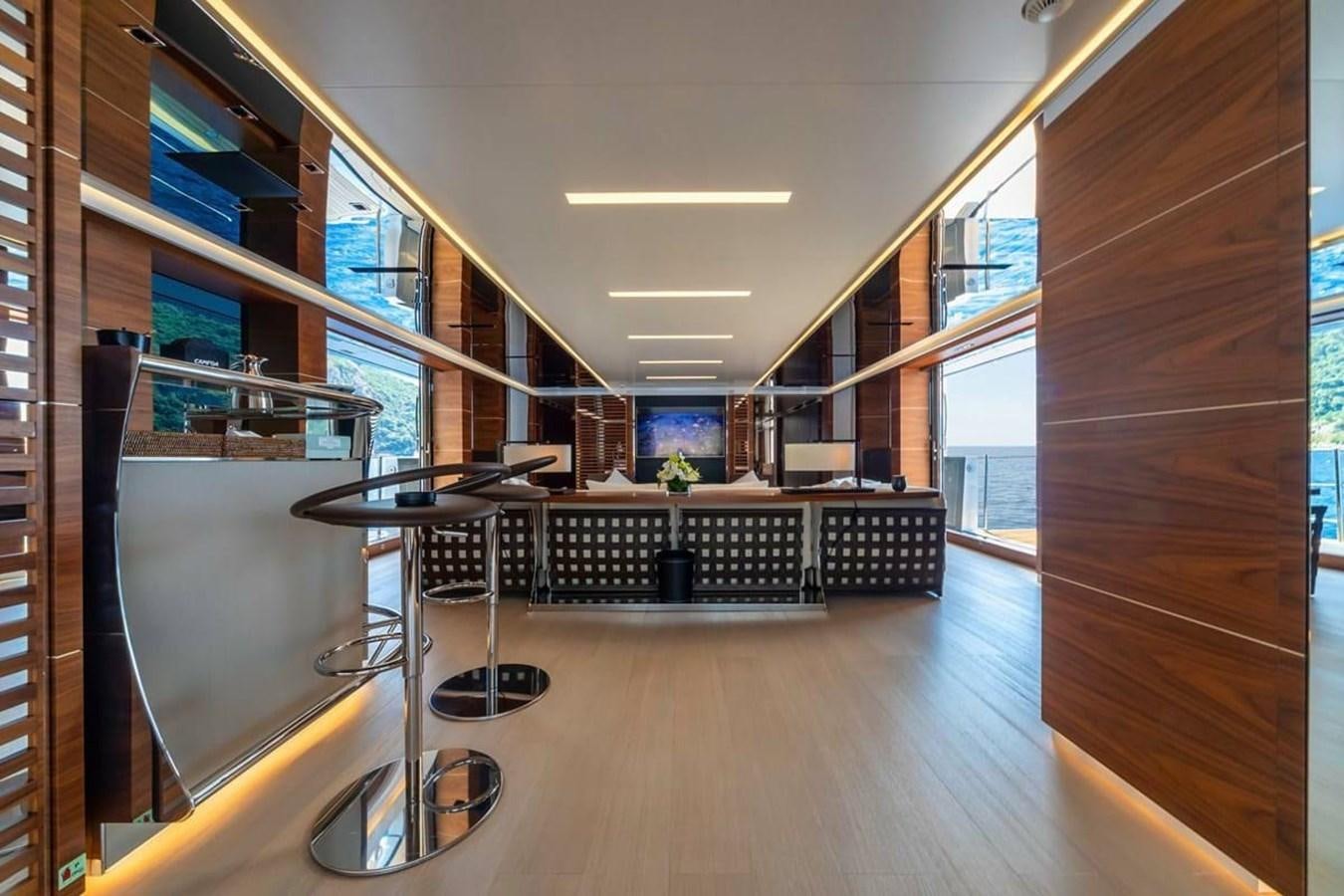a room with a table and chairs aboard LADY A Yacht for Sale