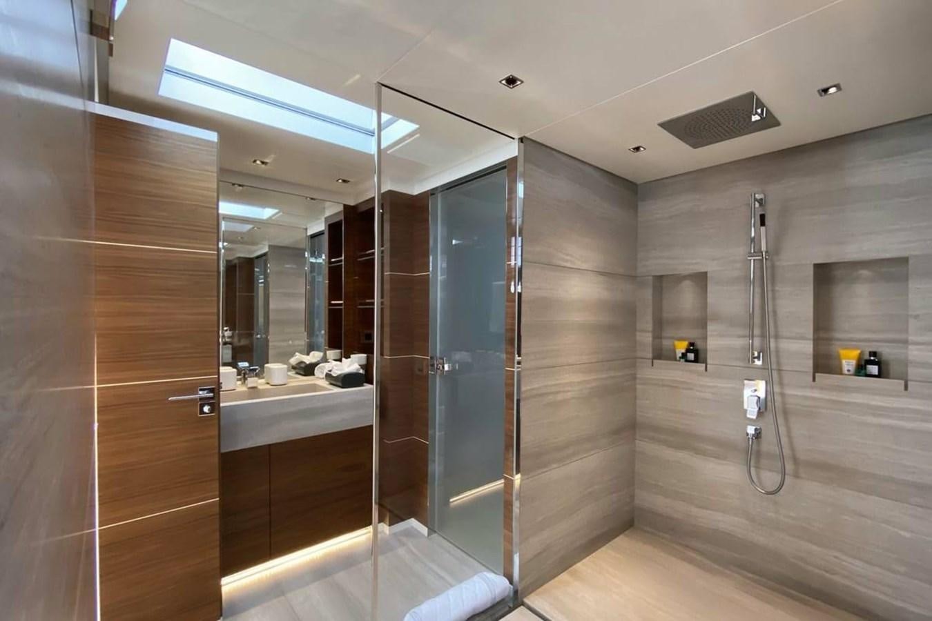 a bathroom with a glass shower aboard LADY A Yacht for Sale