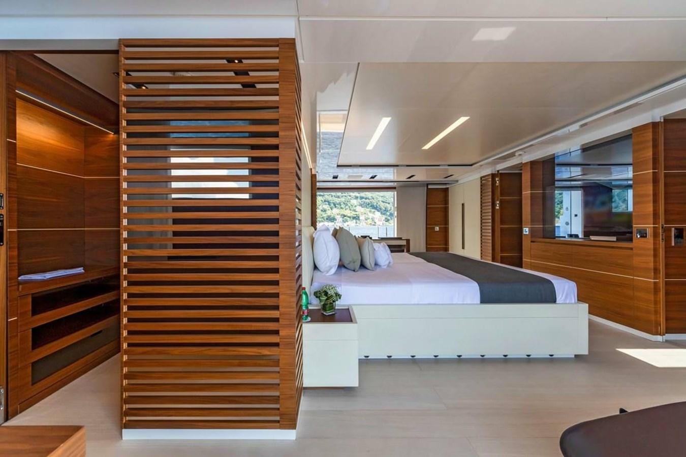 a bedroom with a bed and a closet aboard LADY A Yacht for Sale