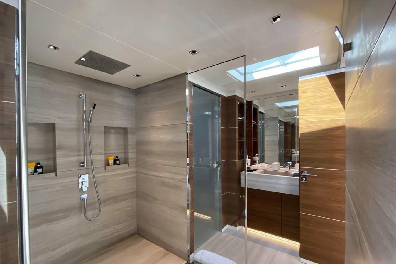 a bathroom with a shower unit and sinks aboard LADY A Yacht for Sale
