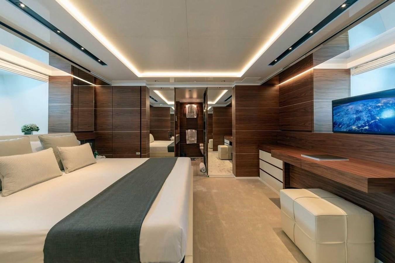 a room with a bed and a desk aboard LADY A Yacht for Sale
