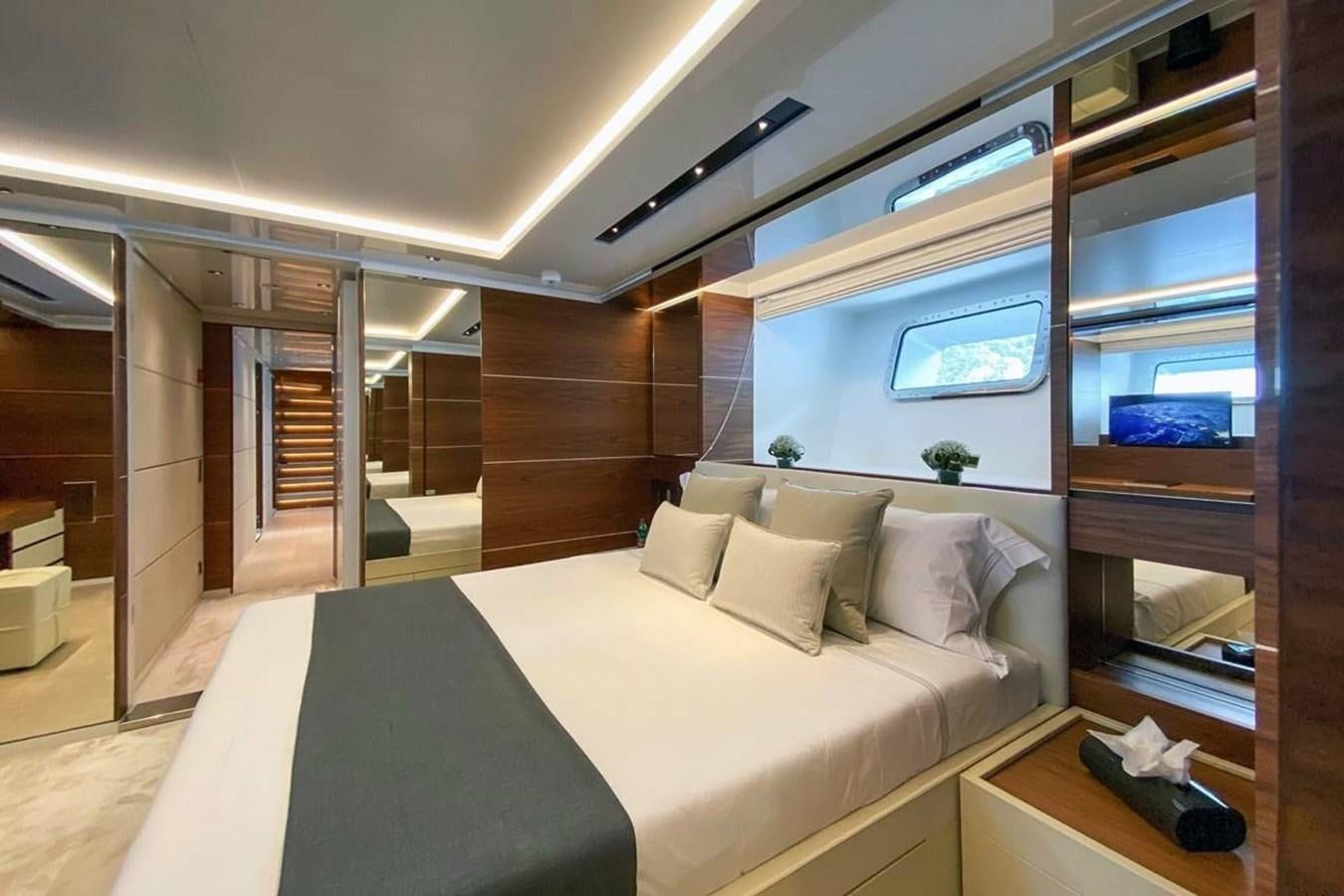 a room with a bed and a window aboard LADY A Yacht for Sale