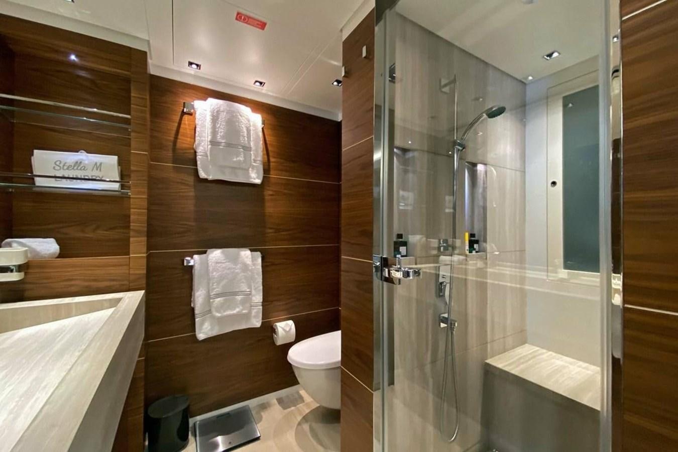 a bathroom with a glass shower aboard LADY A Yacht for Sale