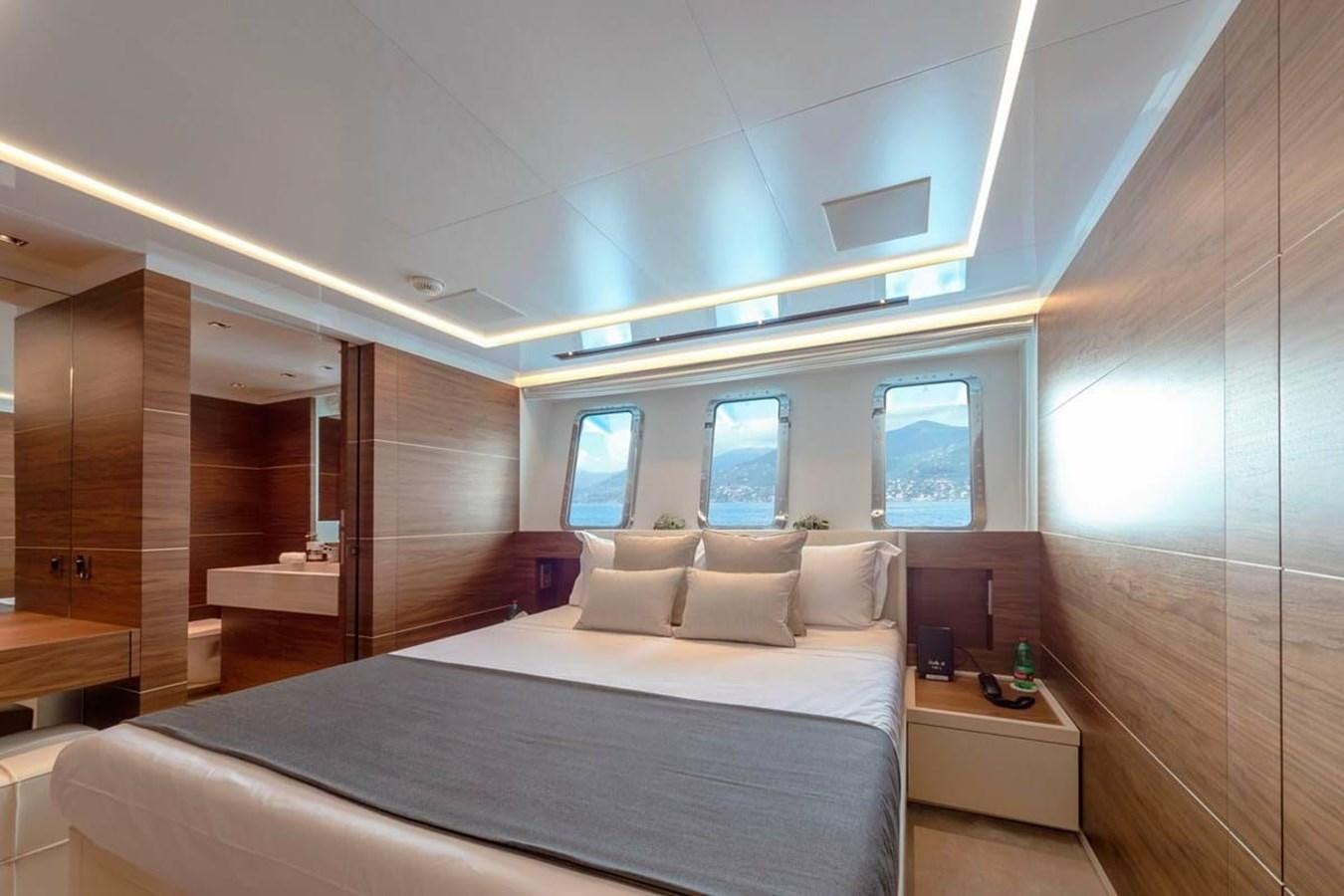 a room with a bed and a window aboard LADY A Yacht for Sale