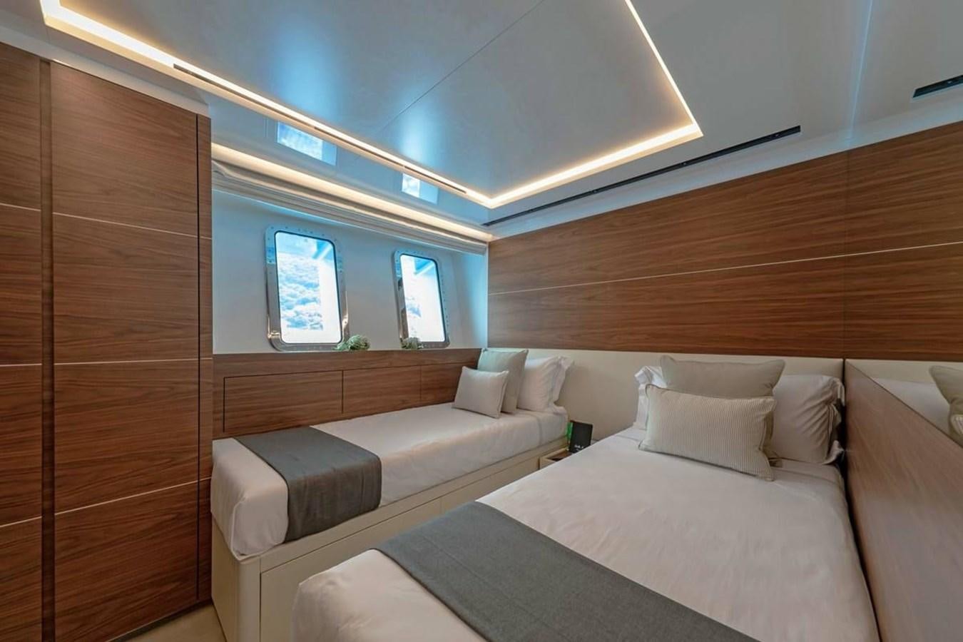 a room with a bed and a window aboard LADY A Yacht for Sale