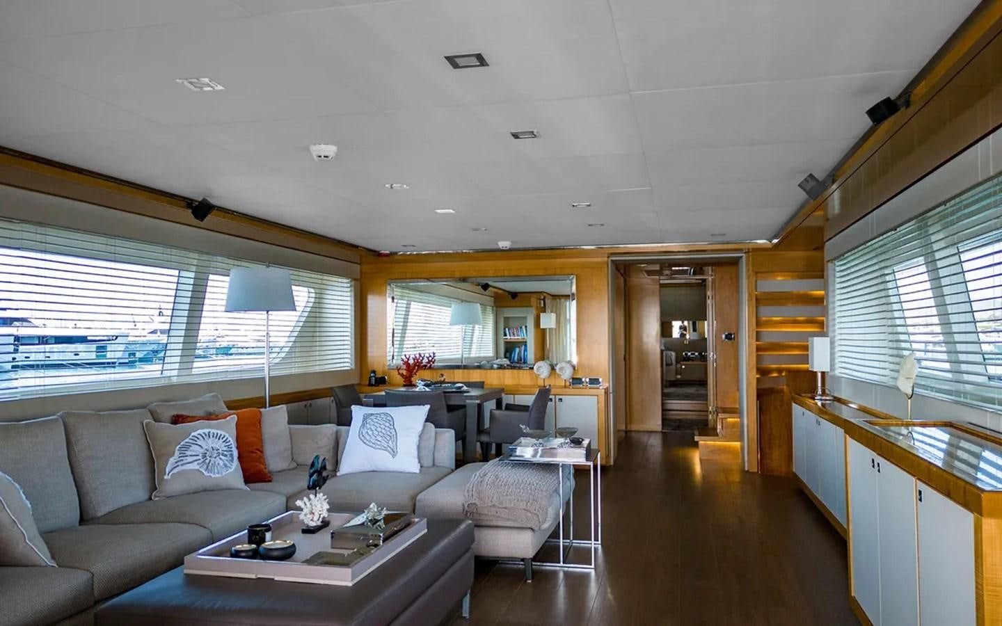 a living room with a couch and a table aboard UNICORN Yacht for Sale