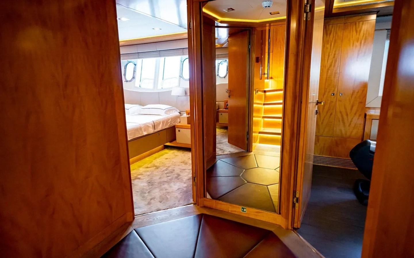 a room with a bed and a door aboard UNICORN Yacht for Sale