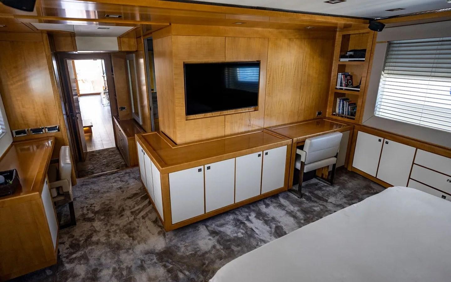 a room with a tv and a bed aboard UNICORN Yacht for Sale