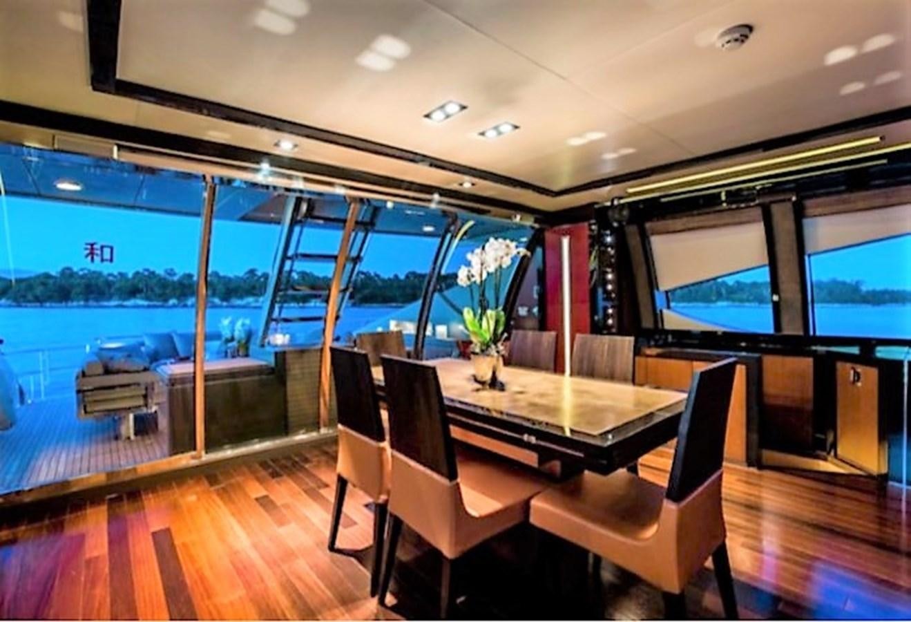a room with a table and chairs aboard MY IZUMI Yacht for Sale