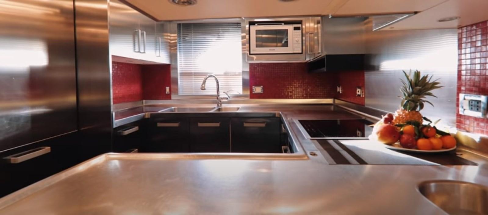 a kitchen with a microwave oven and fruit on the counter aboard MY IZUMI Yacht for Sale