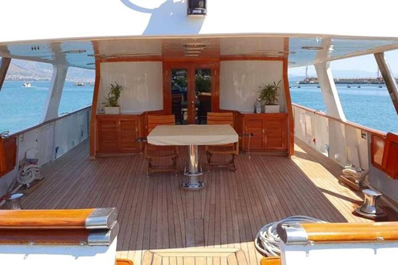 a room with a table and chairs aboard PATRA Yacht for Sale