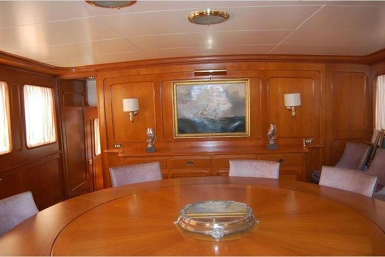 a living room with a table and couches aboard PATRA Yacht for Sale