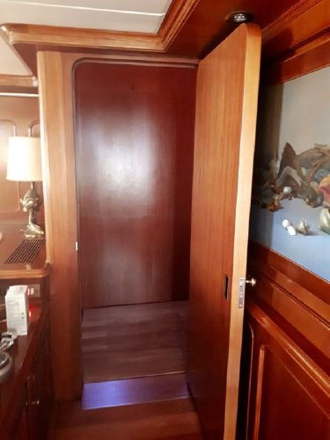 a wood door with a light on it aboard PATRA Yacht for Sale
