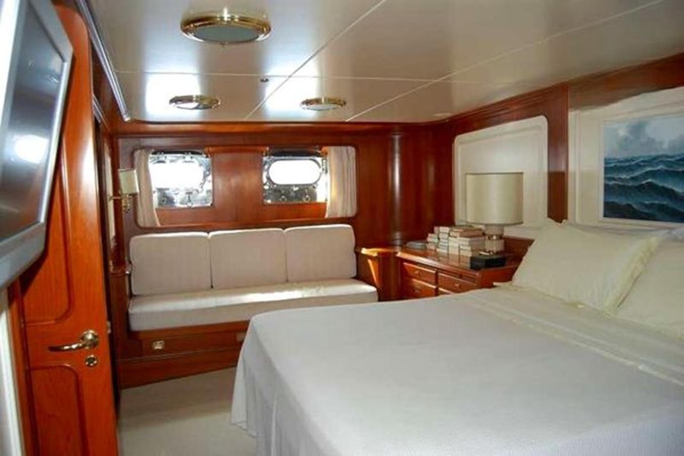 a room with a bed and a couch aboard PATRA Yacht for Sale