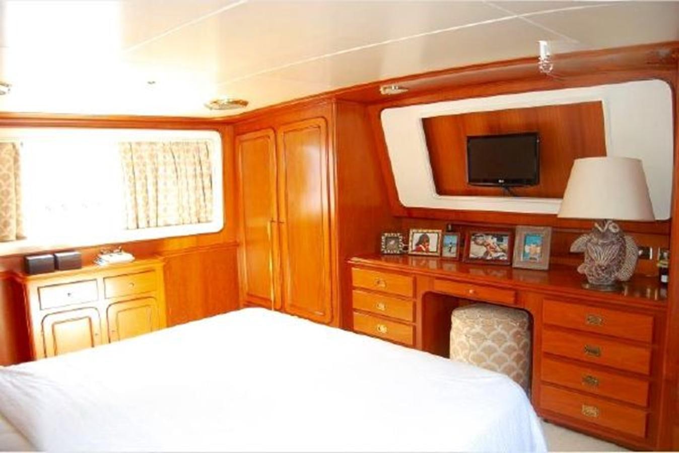 a bedroom with a bed and a television aboard PATRA Yacht for Sale