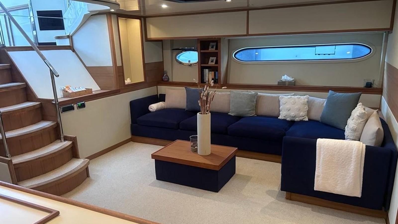 a living room with a blue couch aboard MIDNIGHT MADNESS Yacht for Sale