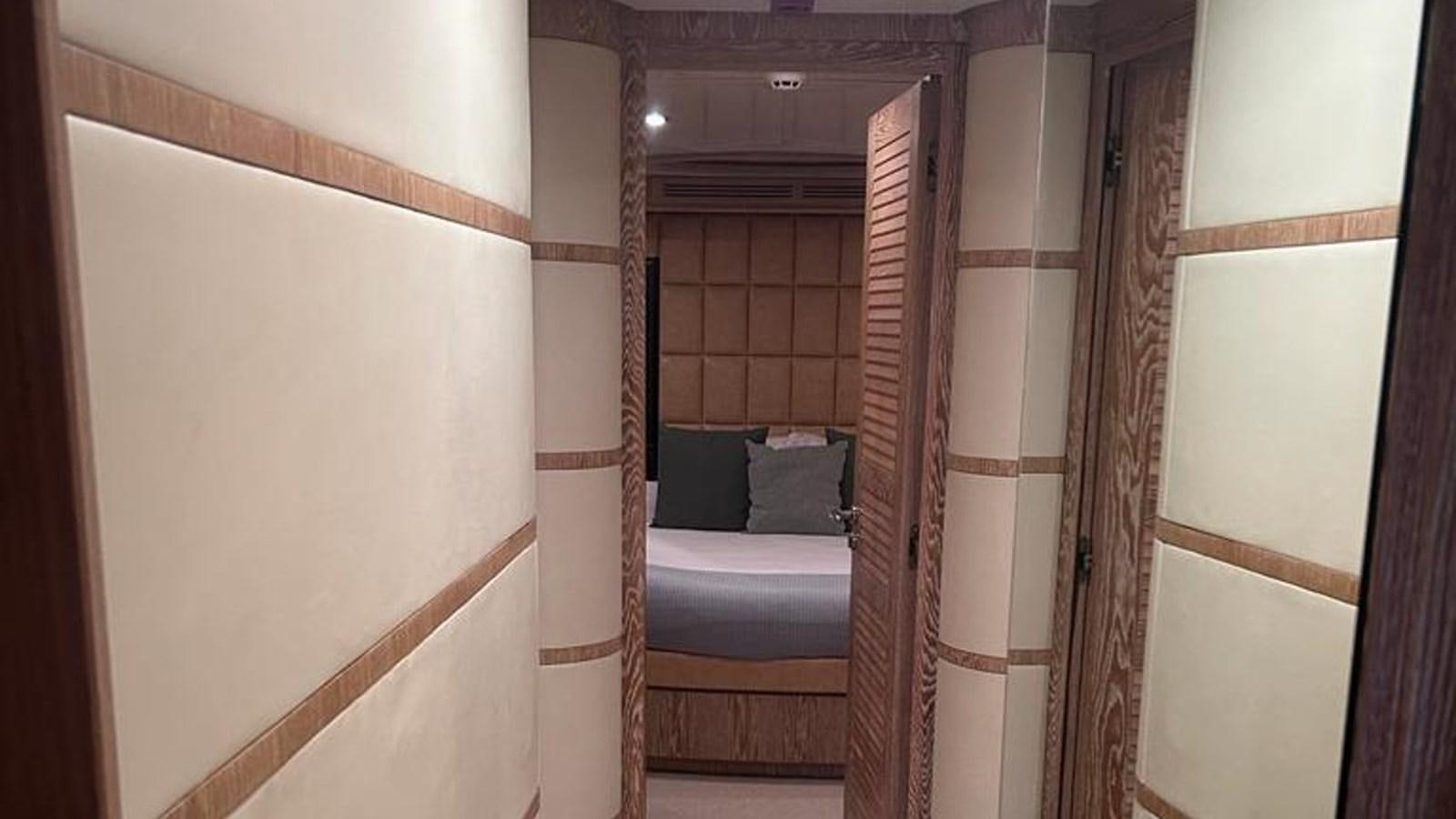 a room with a bed and a door aboard MIDNIGHT MADNESS Yacht for Sale