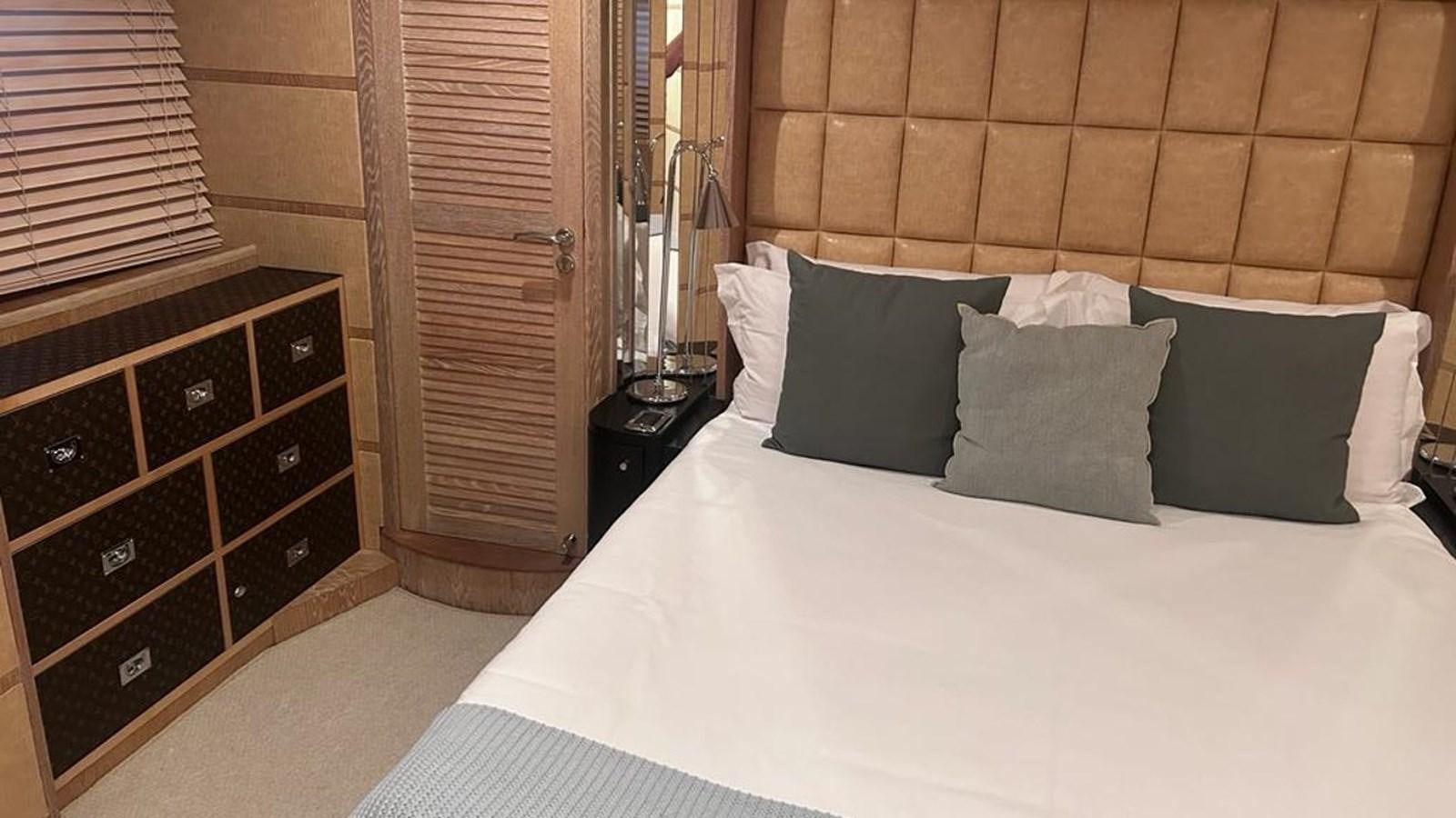 a bed with white sheets and pillows aboard MIDNIGHT MADNESS Yacht for Sale