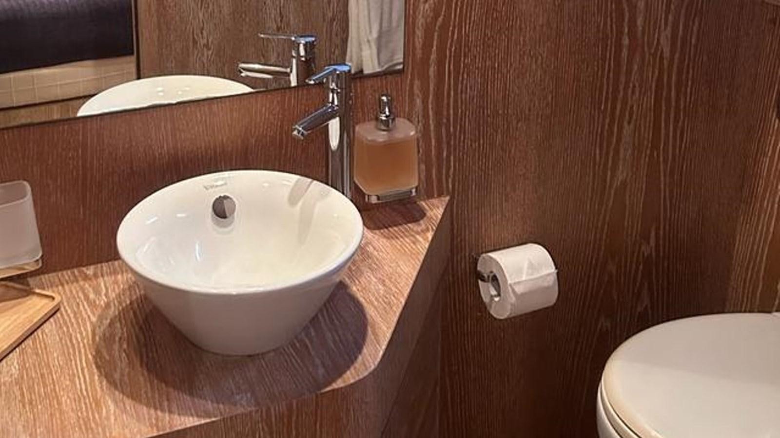 a bathroom with a sink and toilet aboard MIDNIGHT MADNESS Yacht for Sale