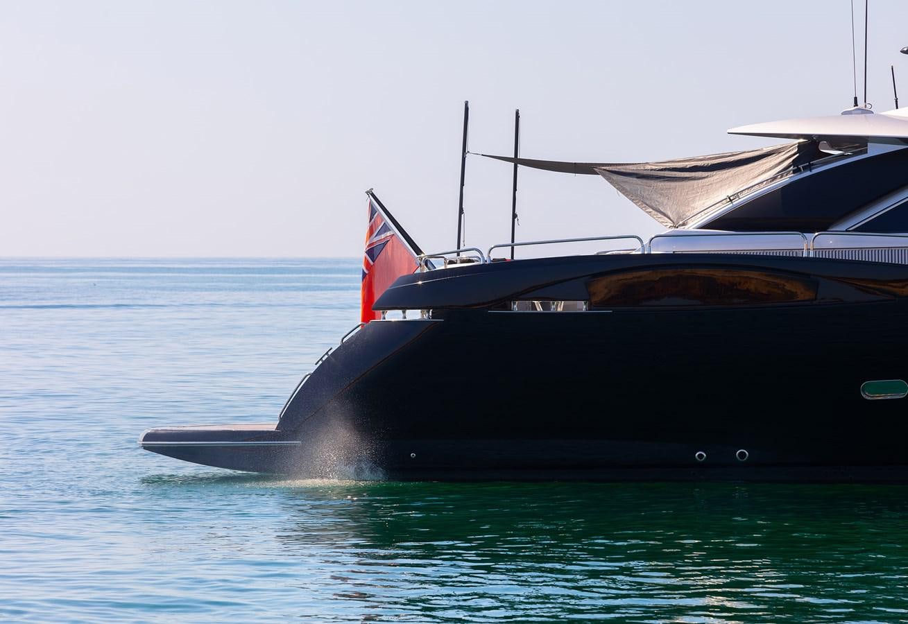 a black boat in the water aboard GEE WHIZZ Yacht for Sale