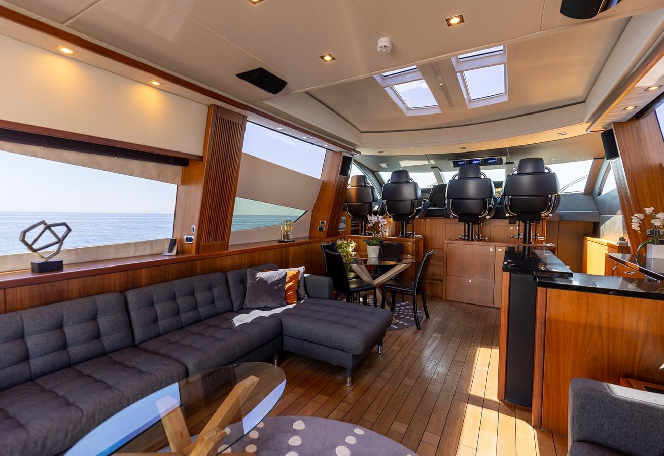 a living room with a couch and a table aboard GEE WHIZZ Yacht for Sale