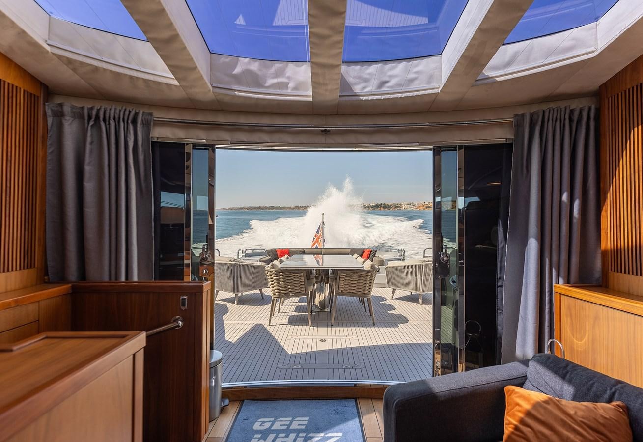 a room with a table and chairs aboard GEE WHIZZ Yacht for Sale