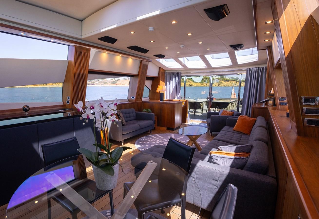 a living room with a large window aboard GEE WHIZZ Yacht for Sale