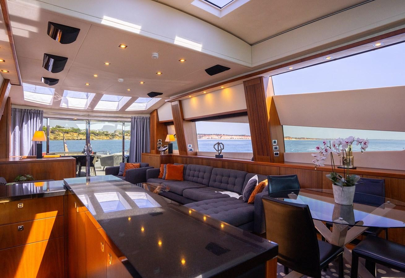 a living room with a large window aboard GEE WHIZZ Yacht for Sale