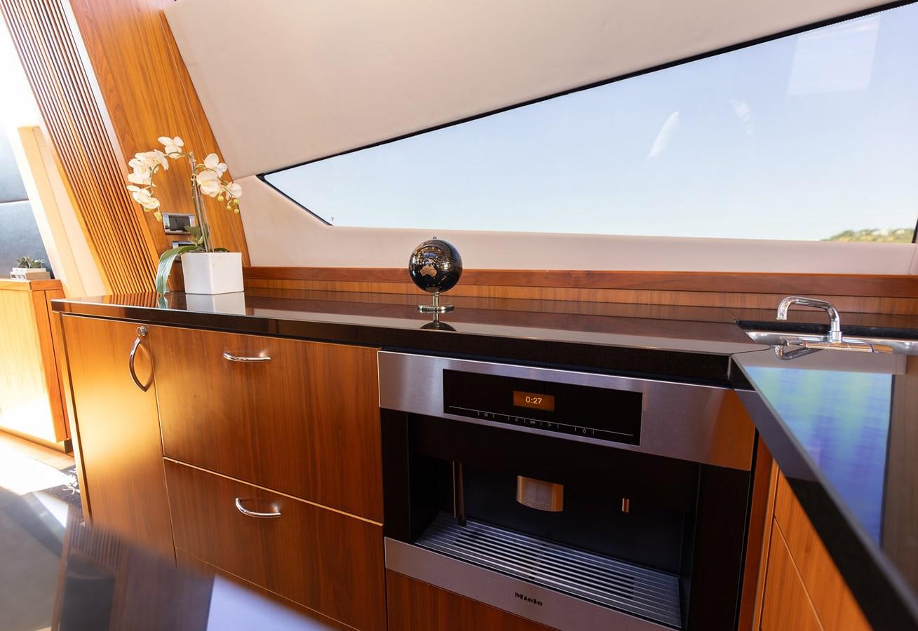 a kitchen with a large window aboard GEE WHIZZ Yacht for Sale