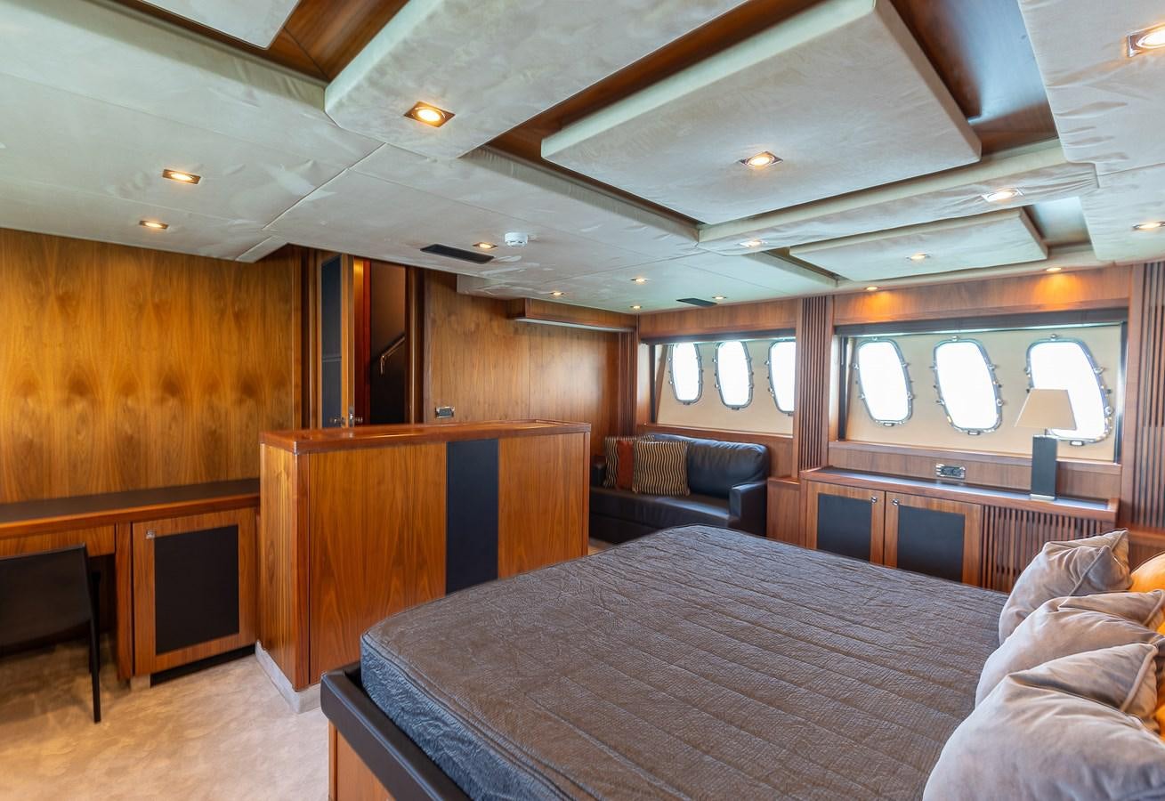 a bedroom with a bed and a couch aboard GEE WHIZZ Yacht for Sale
