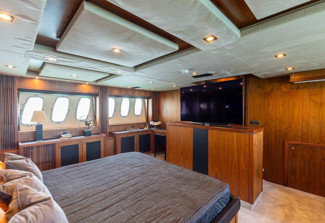 a room with a bed and a television aboard GEE WHIZZ Yacht for Sale