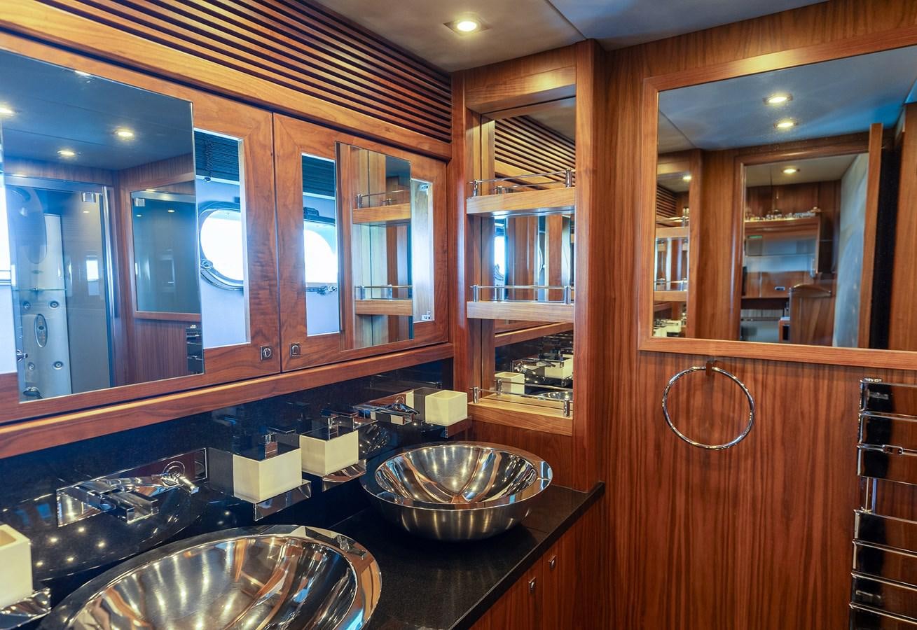 a kitchen with wooden cabinets aboard GEE WHIZZ Yacht for Sale