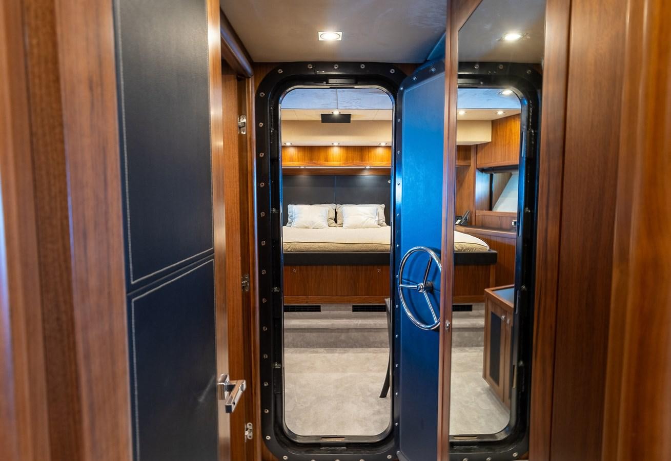 a door with a blue handle aboard GEE WHIZZ Yacht for Sale