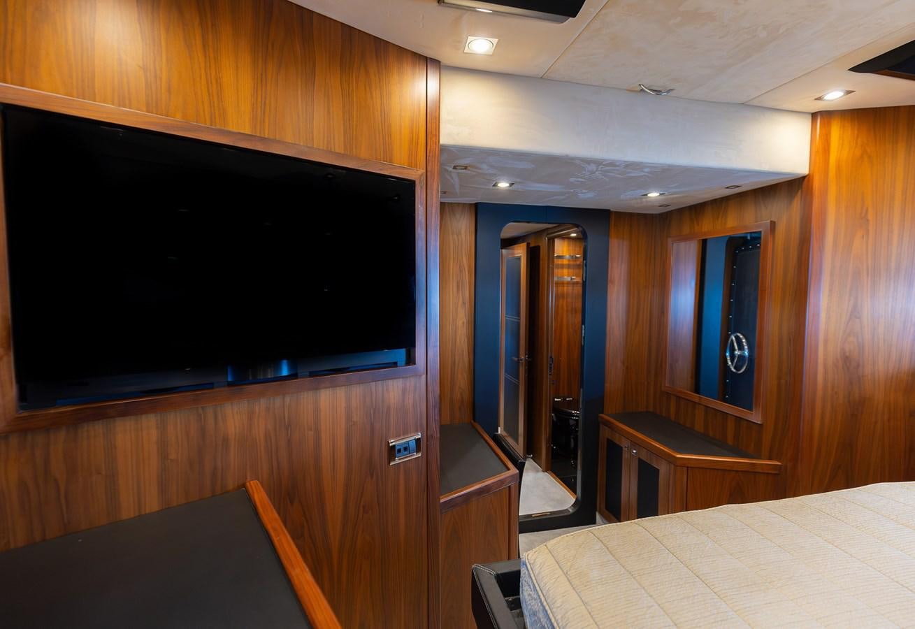 a room with a tv and a bed aboard GEE WHIZZ Yacht for Sale
