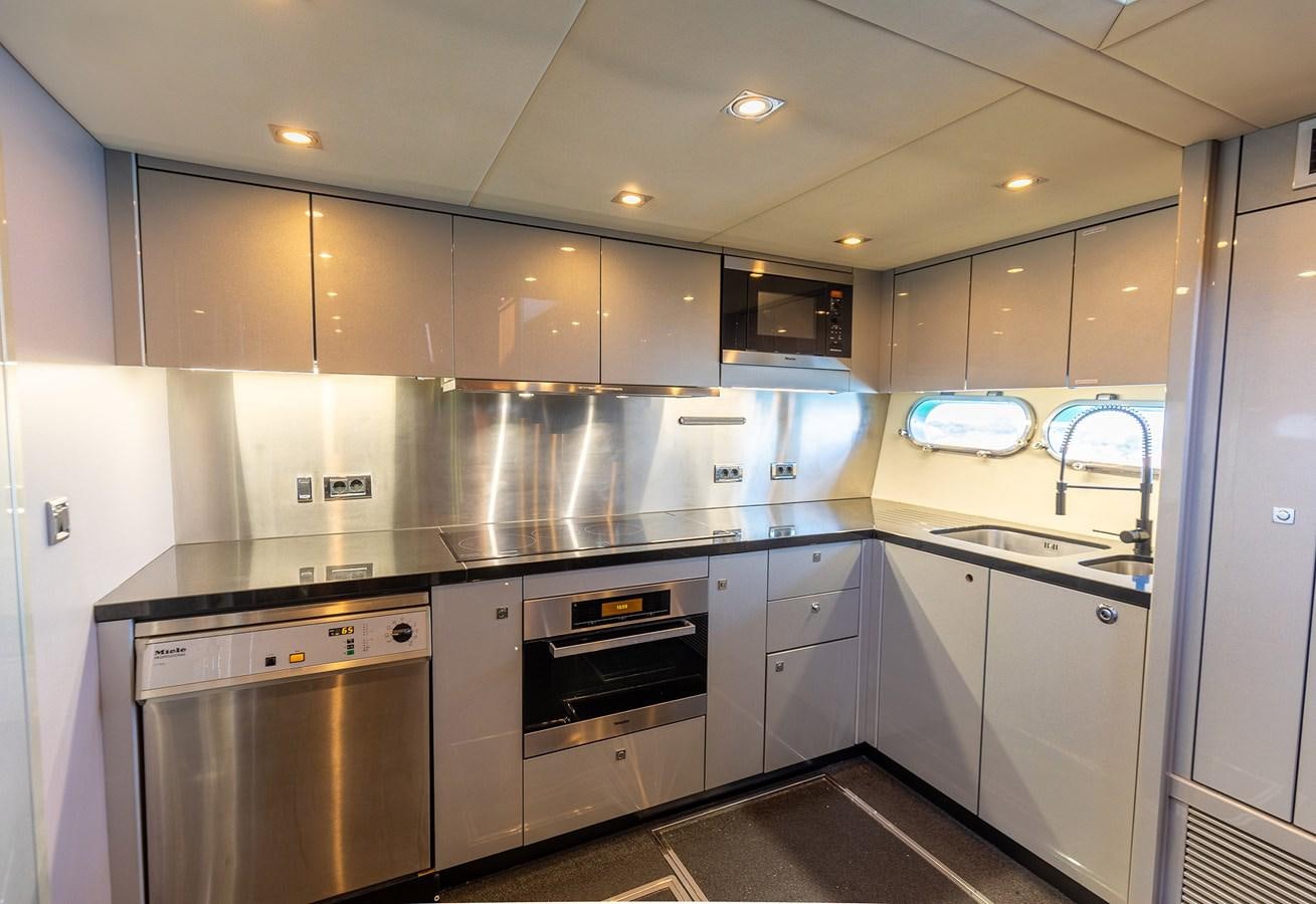 a kitchen with stainless steel appliances aboard GEE WHIZZ Yacht for Sale