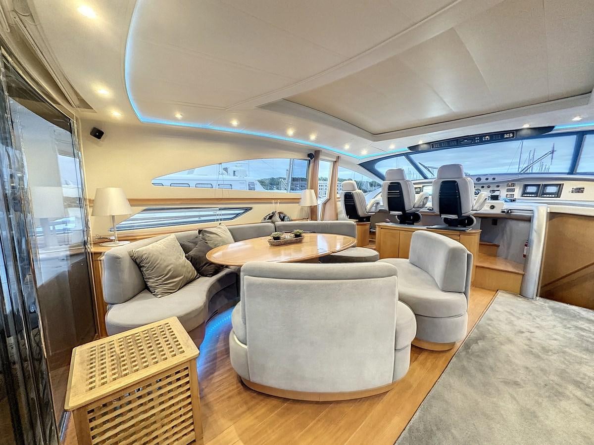 a room with a table chairs and a tv aboard NAUTILUS Yacht for Sale